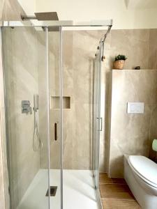 a shower with a glass door in a bathroom at Casa Blaserna nel Cuore dello Shopping a Marconi e Trastevere in Rome +21 photos