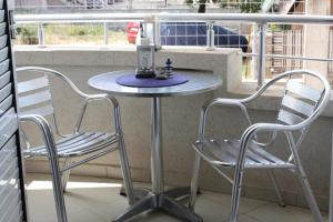a table and two chairs on a balcony at Villa ALEA in Dobra Voda