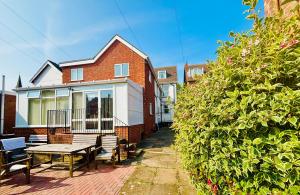 a house with a picnic table in front of it at Springfield Holiday Apartments HALodge Hotel in Skegness