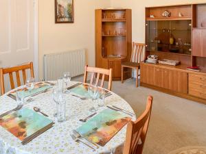 a dining room with a table with glasses on it at Atlantic House - 27665 in Port Isaac