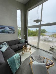 a living room with a couch and a large window at Great Sea View in Kristiansand