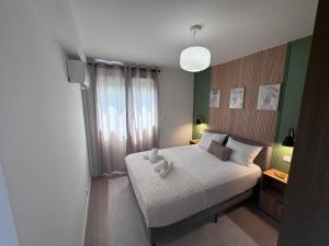 a bedroom with a bed with a teddy bear on it at LE CARRAS - Proche de aéroport , Plage à pied - Promenade des anglais in Nice