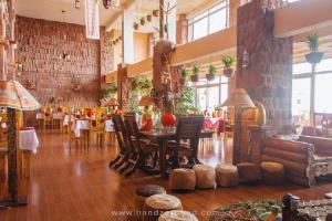 a restaurant with a table and chairs in a room at Maribela Hotel in Lalibela