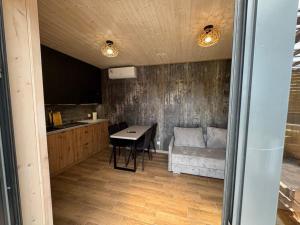 a kitchen and dining room with a table and a couch at H&Z Radawa Zosia in Radawa