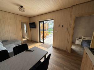 a room with a bed and a table with chairs at H&Z Radawa Zosia in Radawa