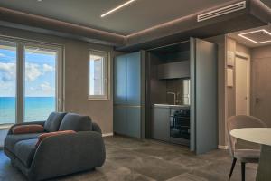 a living room with a couch and a table at THALORA - Luxury Apartments in Bari