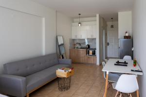 a living room with a couch and a table at Serenity Stay in Messini