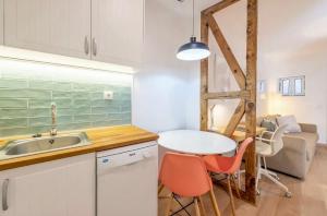 a kitchen with a sink and a table with chairs at Casa Alfama Apartment in Lisbon +6 photos