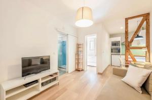 a living room with a television and a couch at Casa Alfama Apartment in Lisbon
