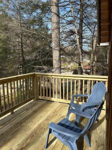 a blue rocking chair sitting on a wooden deck at Homestead Cabin Red River Gorge in Irvine +12 photos