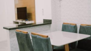 a white table and chairs in a room at renascer in Mauá