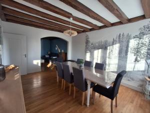 a dining room with a table and chairs at Les 3 champs in Lavault-Sainte-Anne