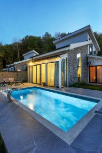una piscina frente a una casa en New Balturk Nature Villas, en Sapanca