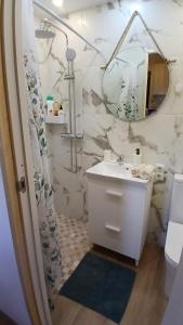 a bathroom with a sink and a mirror at Студия для отдыха в горах in Guía de Isora