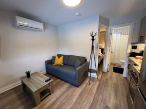 a living room with a couch and a table at Adrian's Suites 1 Bedroom Junior Suite in Wasaga Beach