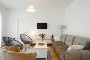 a living room with a couch and chairs and a tv at Harmony Point in Bar