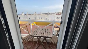 a balcony with a bench and a view of a city at CASA ENTERA PLAYA PUERTO del ROSARIO in Puerto del Rosario