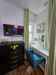 a bedroom with a desk and a blue chair at Central Chambers Suites Suite 3 in Leek