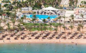 an overhead view of a beach with chairs and palm trees at فندق ميراج باي in Hurghada