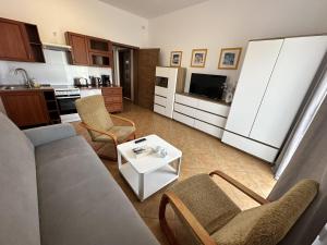 a living room with a couch and a table at Przedsiębiorstwo Turystyczne "SOL" in Grzybowo