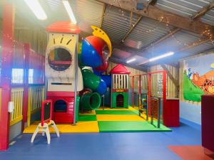 a childrens play room with a colorful playground at Calm View in St Austell