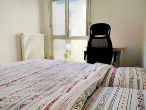 a bedroom with a bed and a chair in front of a window at Opposite Metro 14, Cozy Guest Room with Garden & Free Parking, 5 min Orly Airport, 7 min Paris in Chevilly-Larue
