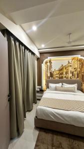 a bedroom with a large bed with curtains in it at Hotel Casa Inn in Indore