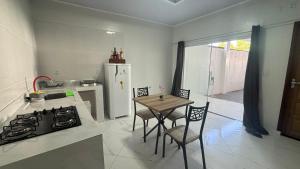 a kitchen with a stove and a table with chairs at espaço R&H in Macapá