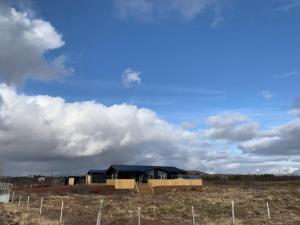 a house under construction in a field at Kerengi Cottage Modern Cozy Cabin Built Late 2024, Heart of Golden Circle Iceland in Selfoss