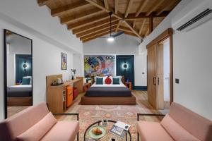a hotel room with a bed and two chairs at Tinspiro Alaçatı in Alacati