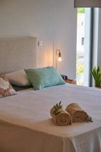 a bed with two towels on top of it at Sky House by Everkind in Viana do Castelo