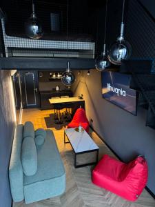 a living room with a couch and a table at Black IN Palangos loftai in Palanga