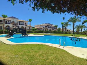 a swimming pool in front of a villa at Veradreams SPA thalassa in Playas de Vera