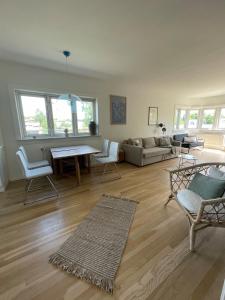 a living room with a couch and a table and chairs at Hotel apartment - Oslo city center - spacious top floor apt with big private balcony in Oslo