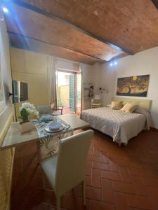 a bedroom with a bed and a table and a dining room at Il Giardino di Barbara in Prato
