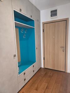 an empty room with a blue window and a door at Lazure apartment in Tivat +5 photos