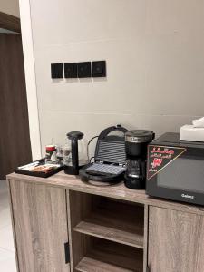 a kitchen counter with a coffee maker and a microwave at شقة فندقية حديثة غرفة نوم وصالة ومطبخ in Al Madinah +29 photos