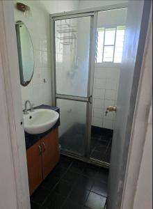 a bathroom with a shower and a sink at MalaudeAirBNB in Suva
