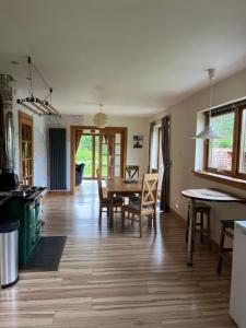 a kitchen and dining room with a table and chairs at The Neuk Achmore Plockton in Stromeferry