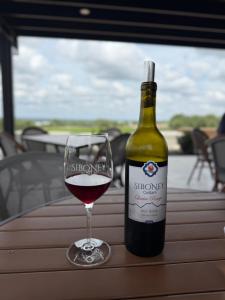 a bottle of wine and a glass on a table at Garofalo Cottage at Wrenwood Ranch, King Bed in Johnson City +25 photos