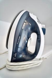 a iron sitting on top of a pile of towels at The Poet´s Corner Holiday Home in Triana