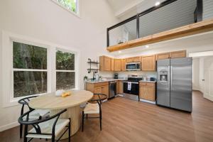 a kitchen with a table and chairs and a refrigerator at Appalachian Cottage in Blowing Rock