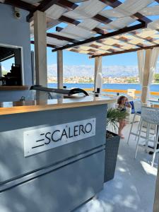 a restaurant counter with the scelvo logo on it at Studio Apartment Bella in Selca