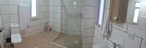 a bathroom with a shower and a toilet at Pousada Siriemas in Cambara do Sul +7 photos