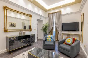 a living room with a large mirror and a tv at Antiqua Domus in Rome