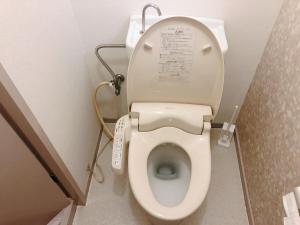 a small bathroom with a toilet in a stall at Station Front JUSO EAST 402 No Lift in Osaka +16 photos