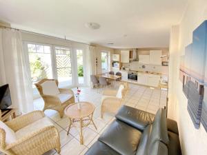 a living room with a couch and a table at Nordlicht - Strandkorb EG in Timmendorf