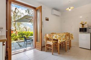 a kitchen with a table and a kitchen with a balcony at Lake Garda Apartment - Panorama in Brenzone sul Garda