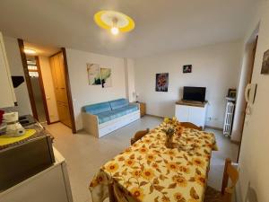 a living room with a table and a couch at Lake Garda Apartment - Panorama in Brenzone sul Garda