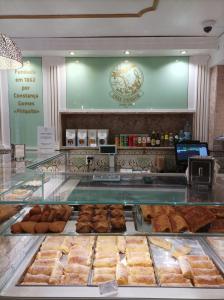a bakery with a display case filled with lots of pastries at Sintra Real Apartment in Sintra +6 photos